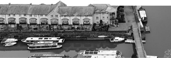 Aerial view of boats docked along a canal with charming townhouses