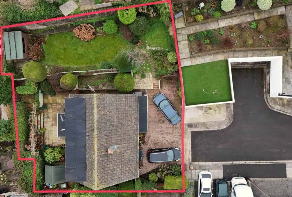 Aerial view of a residential plot directly from above, with a red boundary surround.